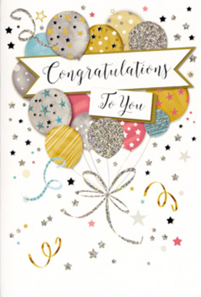 The photograph showcases a refined congratulations card whose design feels as thoughtfully composed as a celebratory bouquet arranged for a special occasion in Becontree Heath. The main visual element is a flourishing cluster of balloons, grouped together in the centre of the card and reaching gently upwards, as if buoyed by shared happiness and pride. Each balloon is unique in colour and pattern, yet they all harmonise: soft golds and champagnes, quiet silvers, powder blues, rose-tinted pinks, and smooth greys overlap in gentle layers. Subtle metallic accents-fine stripes, scattered star motifs, and tiny flecks of glitter-sit on the surface of the balloons, giving the impression of soft texture and a quiet shimmer each time the card moves in the light. Slim curling strings in gold and silver cascade from the base of the balloon cluster, looping and crossing over one another in delicate lines that mirror the flowing stems and ribbons on a hand-crafted floral arrangement ready for delivery to a Becontree Heath doorstep. Through the heart of the design, a wide banner sweeps from side to side, carrying the message Congratulations To You in elegant, calligraphic script. The lettering appears slightly raised and confidently centred, like a spoken toast at a family gathering along Becontree Avenue or near the local shops. Around the central balloons, tiny metallic stars, ribbon curls, and scattered sparkling dots float against a clean, pale background, evoking confetti tossed in the air at the moment great news is shared. The overall atmosphere is polished but warm, perfectly suited to marking milestones, exam successes, new beginnings, or any proud achievement that deserves both flowers and a beautifully considered card.