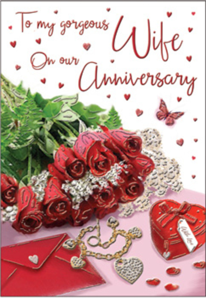 An emotionally rich tableau unfolds in this anniversary card image, capturing the warmth and romance of a celebration in Becontree Heath. At its centre stands a bouquet of classic red roses, each bloom fully open and luxuriously layered, the petals softly curled and satin-like to the eye. Their intense crimson colour conveys deep affection and long-standing devotion, while lush greenery winds around the stems, enhancing the feeling of natural abundance and freshness. The roses appear elegantly wrapped or arranged, as if prepared by a skilled florist who understands how to balance drama and tenderness. Surrounding this central cluster are delicate touches that tell a story of shared years: a jewellery set glinting under the light, its metal and stones reflecting warm highlights, and a vivid red box that suggests a gift carefully chosen and lovingly presented. Fine, whisper-thin lace and dainty heart motifs weave through the composition, catching the eye with their detailed patterns and soft textures. A neatly placed envelope rests nearby, its presence hinting at heartfelt words written in private, perhaps exchanged over coffee in a Becontree Heath kitchen or after a stroll through the local green spaces. The card's scripted message curls gracefully across the surface, surrounded by scattering hearts that echo the roses' romantic theme. Textures of velvet, silk-like ribbon, smooth paper, and gleaming jewellery create a tactile richness that makes the image feel almost touchable. The overall atmosphere is one of quiet yet powerful romance, perfectly capturing the essence of an anniversary moment filled with gratitude, memory, and renewed commitment.