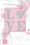 This anniversary card offers a gentle celebration of enduring romance, its surface unfolding with the same calm grace as an unhurried walk around Becontree Heath's central gardens. The design is anchored by the word LOVE, spelled out in soft, raised glitter that adds both visual shimmer and subtle texture to the card. The O is replaced by a gleaming silver heart, its surface finely textured so that it stands out as the emotional centre of the composition. Surrounding this heartfelt focal point, clusters of delicate blooms in blush, rose-pink, and muted mauve drift across the card with an almost watercolour softness. Their fluid outlines and shaded petals conjure the image of a florist painting with flowers, much as one might arrange a bespoke anniversary bouquet for delivery to nearby homes and cosy flats. Fine, silvery swirls and slender vines link the blossoms together, while small petals and understated butterfly shapes are scattered like confetti in the air. The colour palette-soft pastel pinks contrasted with silvery greys-creates a quiet, intimate mood, ideal for marking a shared journey filled with everyday moments and treasured milestones. The front of the card features the words On Our Anniversary, while inside the sentiment I love you today and always appears in an elegant, flowing script that curves gracefully across the page. The lettering feels personal and heartfelt, as though carefully written by hand. Overall, the card resembles a paper garden in bloom, its gentle sparkle and layered florals expressing deep affection and continuity, much like a relationship that has grown steadily and beautifully over time in Becontree Heath and the surrounding neighbourhoods.